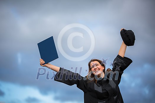 Pretty, young woman celebrating joyfully her graduation - spreading wide her arms, holding her diploma, savouring her success (color toned image; shallow DOF) Pretty, young woman celebrating joyfully her graduation - spreading wide her arms, holding her diploma, savouring her success (color toned image; shallow DOF)