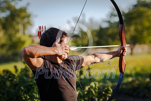 Young archer training with the bow Young archer training with the bow