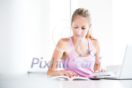On campus - pretty, female student with books and laptop working while on a college/university campus (color toned image, shallow DOF) On campus - pretty, female student with books and laptop working while on a college/university campus (color toned image, shallow DOF)