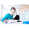 female college student in a library (shallow DOF; color toned image)