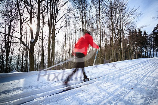 Cross-country skiing: young man cross-country skiing on a lovely sunny winter day (motion blur technique is used to convey movement) Cross-country skiing: young man cross-country skiing on a lovely sunny winter day (motion blur technique is used to convey movement)