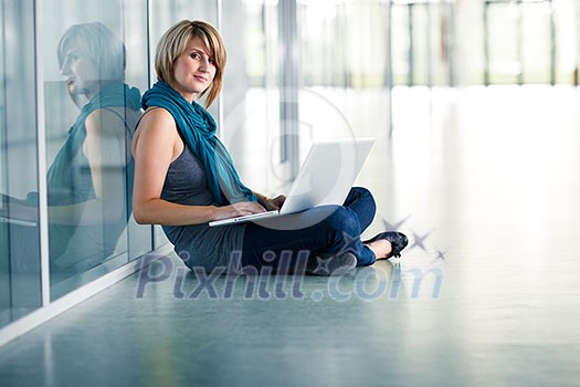 Pretty young female student with a laptop computer on college/university campus (shallow DOF; color toned image) Pretty young female student with a laptop computer on college/university campus (shallow DOF; color toned image)