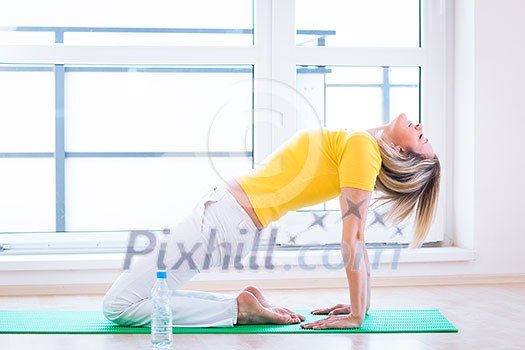 Pretty young woman doing YOGA exercise at home Pretty young woman doing YOGA exercise at home