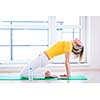 Pretty young woman doing YOGA exercise at home