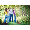 Family portrait - Family of four with a cute dog outdoors