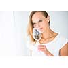 Gorgeous young woman with a glass of wine, smelling the lovely drink, savouring every sip (shallow DOF; color toned image)