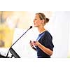 Pretty, young business woman giving a presentation in a conference/meeting setting (shallow DOF; color toned image)