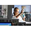 Portrait of a female researcher doing research in a lab (shallow DOF; color toned image)