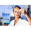 Portrait of a female researcher doing research in a lab (shallow DOF; color toned image)