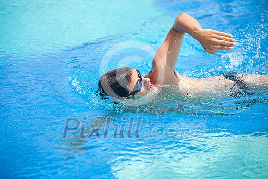 Young man swimming the front crawl in a pool Young man swimming the front crawl in a pool