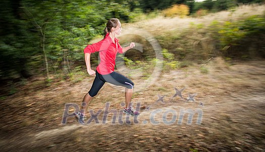 Young woman running outdoors in a forest, going fast (motion blurred image) Young woman running outdoors in a forest, going fast (motion blurred image)