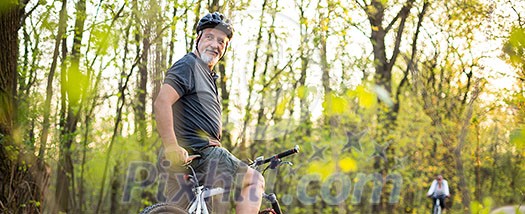 Senior man on his mountain bike outdoors Senior man on his mountain bike outdoors