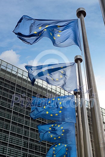 European Union flags in front of the Berlaymont building (European commission) in Brussels, Belgium. European Union flags in front of the Berlaymont building (European commission) in Brussels, Belgium.