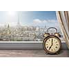 View of Paris and Eiffel tower from window with alarm clock