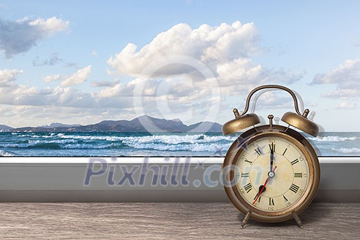 View of summer sea under blue sky from window with alarm clock View of summer sea under blue sky from window with alarm clock