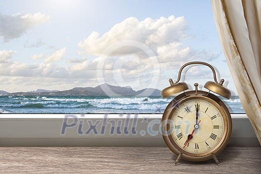 View of summer sea under blue sky from window with alarm clock View of summer sea under blue sky from window with alarm clock