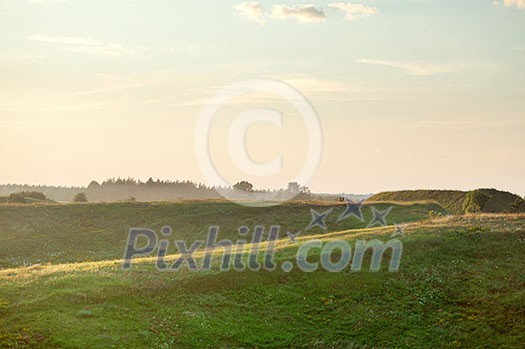 Summer landscape on sunset - field and hills Summer landscape on sunset - field and hills