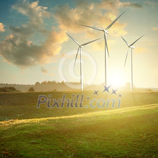 Wind generators turbines on sunset summer landscape Wind generators turbines on sunset summer landscape
