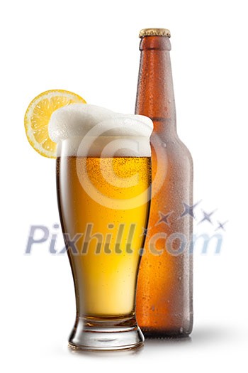 Beer in glass with lemon and bottle isolated on white Beer in glass with lemon and bottle isolated on white