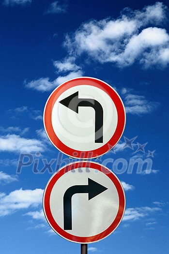 two opposite road signs against blue sky and clouds two opposite road signs against blue sky and clouds