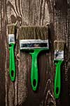 Three brushes for painting on a dark wooden table