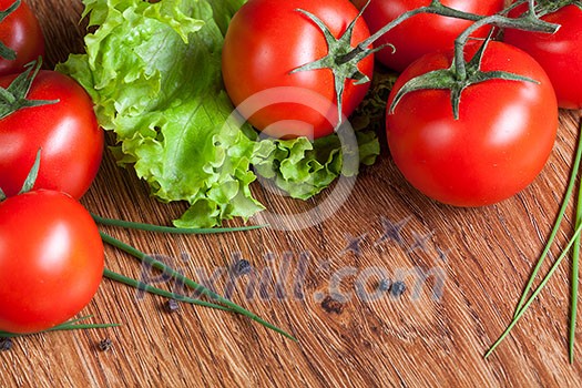 red tomatoes with green salad on wood red tomatoes with green salad on wood