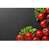 red tomatoes with green salad on black