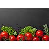red tomatoes with green salad on black