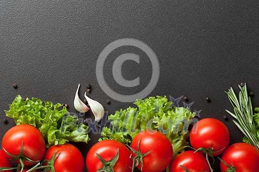 red tomatoes with green salad on black red tomatoes with green salad on black