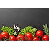 red tomatoes with green salad on black