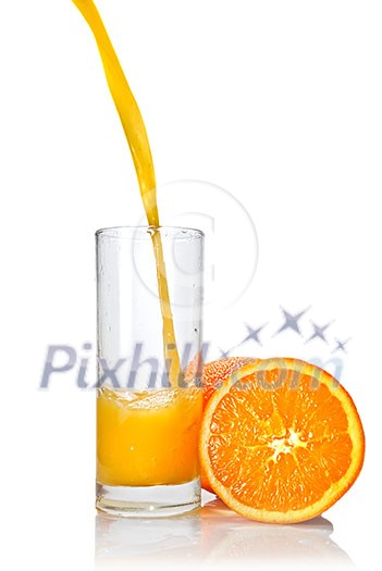orange juice poring into glass isolated on white orange juice poring into glass isolated on white