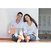 happy young relaxed couple working and playing on laptop computer at home