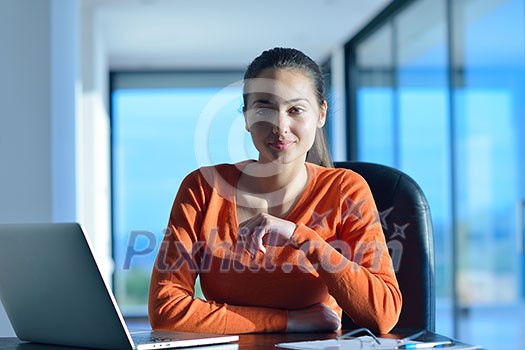 beautiful young woman relax and work on laptop computer while listening music on heaphones and read book at home beautiful young woman relax and work on laptop computer while listening music on heaphones and read book at home