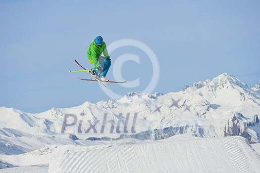 jumping skier at mountain winter snow fresh suny day