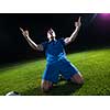 soccer player doing kick with ball on football stadium  field  isolated on black background