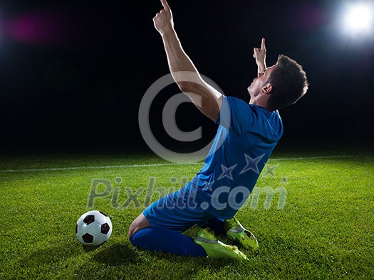 soccer player doing kick with ball on football stadium field isolated on black background soccer player doing kick with ball on football stadium field isolated on black background