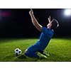 soccer player doing kick with ball on football stadium  field  isolated on black background