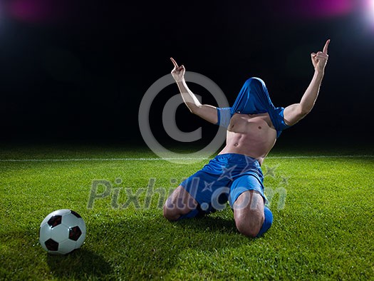 soccer player doing kick with ball on football stadium field isolated on black background soccer player doing kick with ball on football stadium field isolated on black background