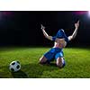 soccer player doing kick with ball on football stadium  field  isolated on black background