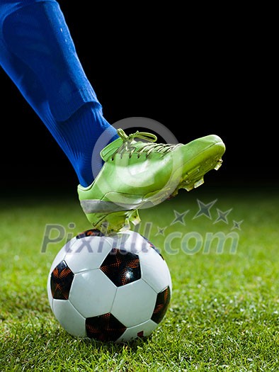 soccer player doing kick with ball on football stadium field isolated on black background soccer player doing kick with ball on football stadium field isolated on black background