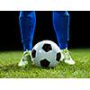 soccer player doing kick with ball on football stadium  field  isolated on black background