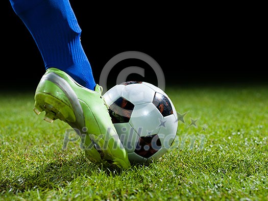 soccer player doing kick with ball on football stadium field isolated on black background soccer player doing kick with ball on football stadium field isolated on black background