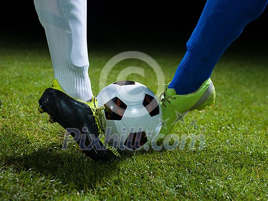 soccer player doing kick with ball on football stadium field isolated on black background soccer player doing kick with ball on football stadium field isolated on black background