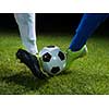 soccer player doing kick with ball on football stadium  field  isolated on black background