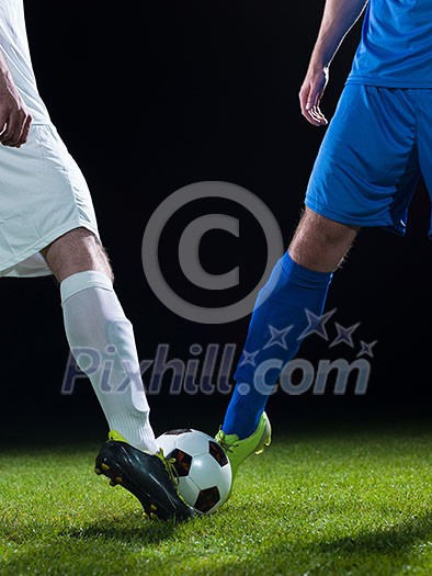soccer player doing kick with ball on football stadium field isolated on black background soccer player doing kick with ball on football stadium field isolated on black background