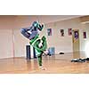 young man performing break dance in dance studio