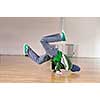 young man performing break dance in dance studio