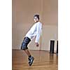 young man performing break dance in dance studio