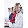 Pretty young business woman group with headphones smiling at you against white background