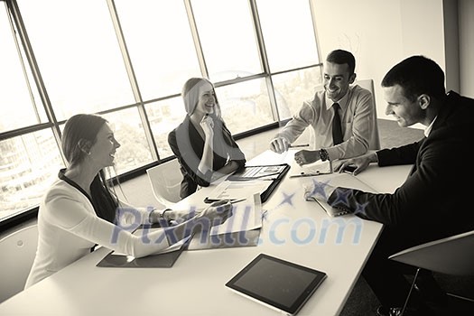 Group of happy young business people in a meeting at office Group of happy young business people in a meeting at office